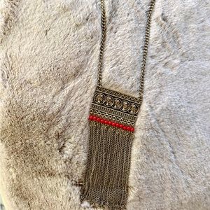 brassy gold statement necklace red detail with coin detail and chain tassels